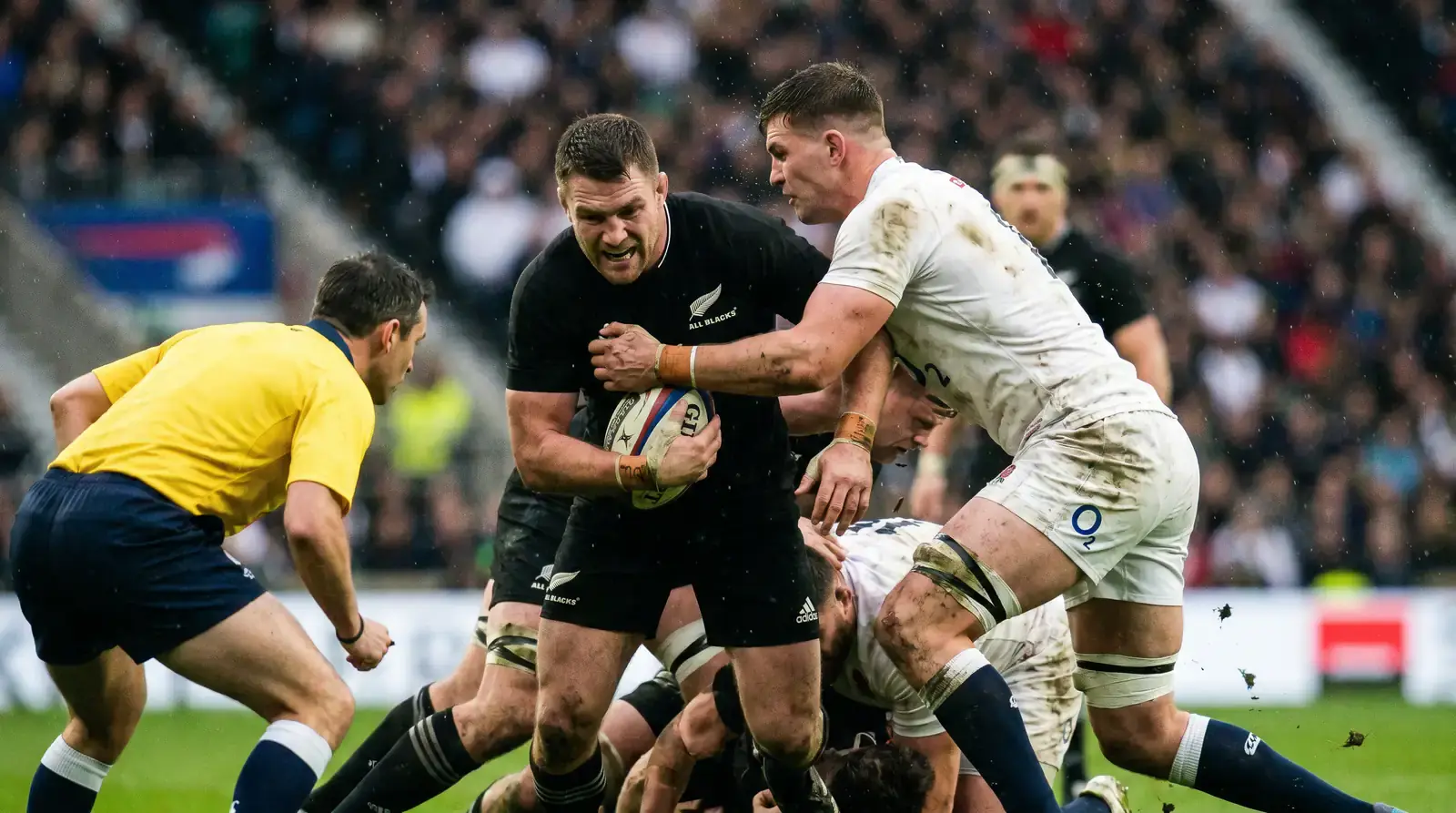 Referee adjudicating a contested breakdown in professional rugby