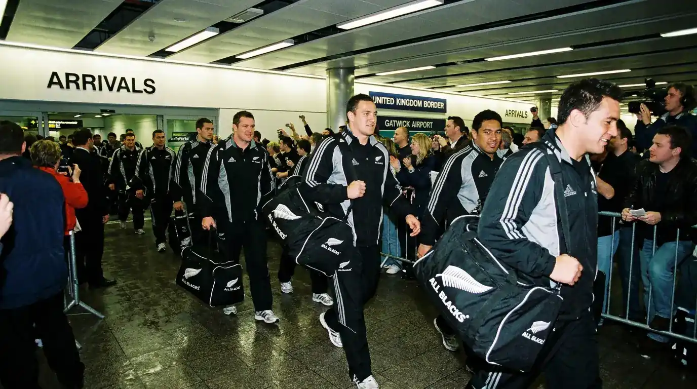 Southern-hemisphere rugby touring side arriving at a UK airport in November